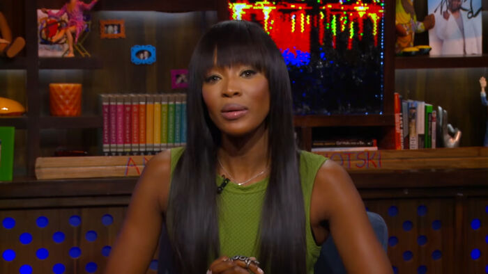 Naomi Campbell sitting during a television appearance, recalling a celebrity encounter
