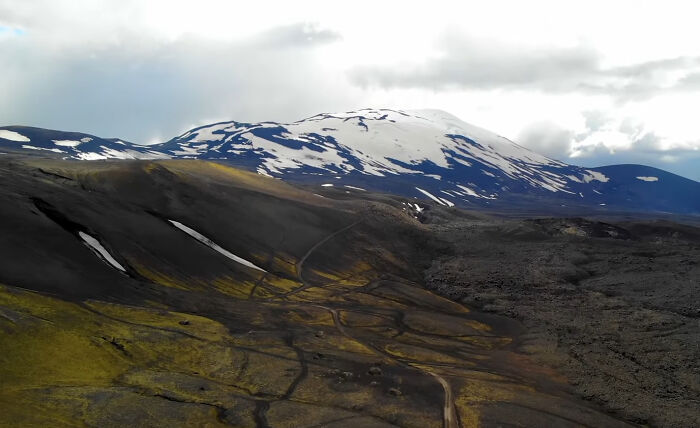 A desolate, snow-capped mountain range with dark, rugged terrain, representing an eerie place. A desolate, snow-capped mountain range with dark, rugged terrain, representing an eerie place.