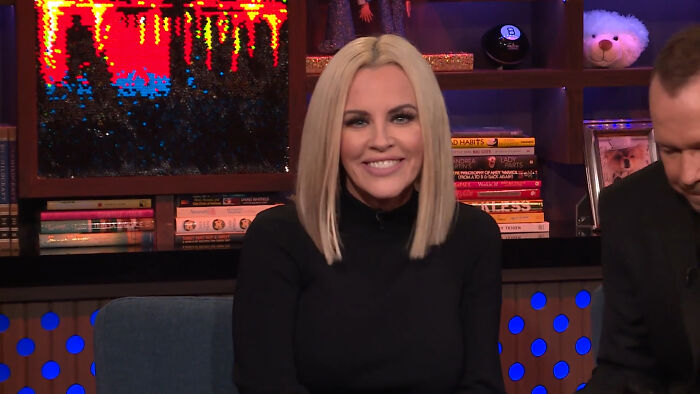 Television host Jenny McCarthy smiling on a late-night talk show set