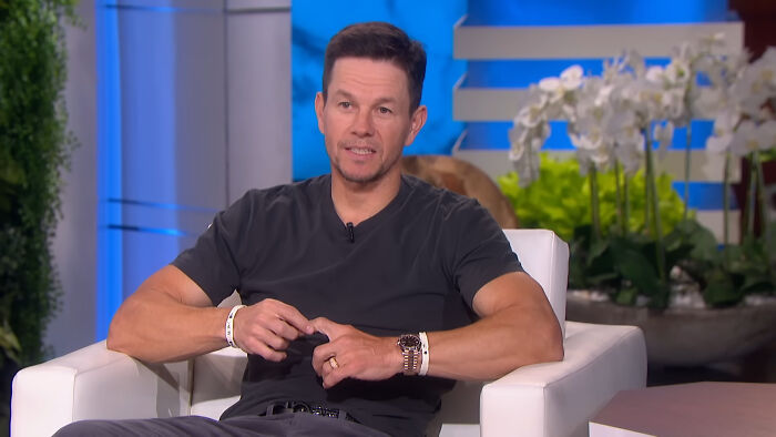Actor Mark Wahlberg wearing a dark grey shirt during a talk show talking about celebrity encounters