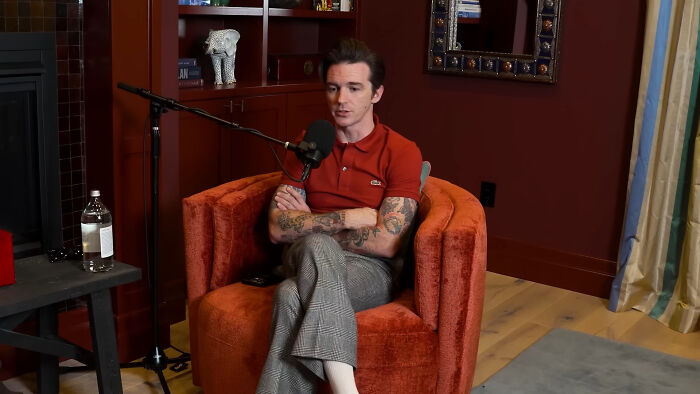 Drake Bell seated for an interview, representing memorable celebrity encounters.