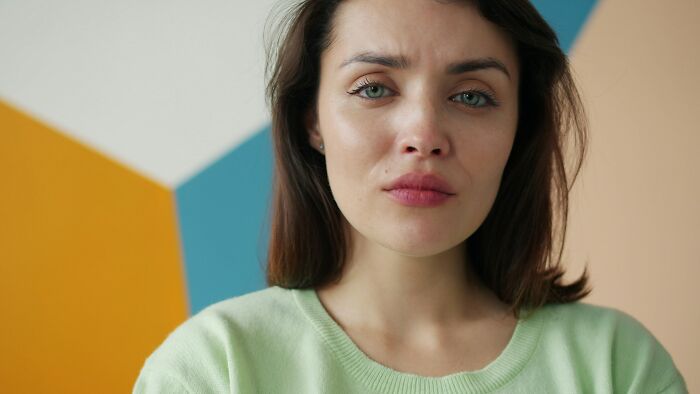 A woman with an expression of dismay, possibly due to lies men told her.