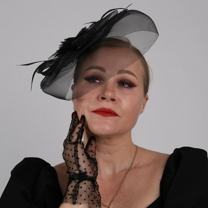 A elegant woman in a black vintage outfit, expressing romance at weddings