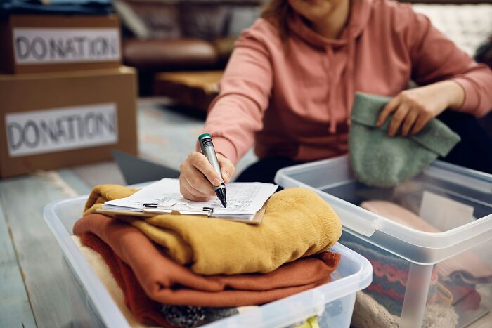 A volunteer sorting donations, demonstrating how people cope when the economy is in trouble.