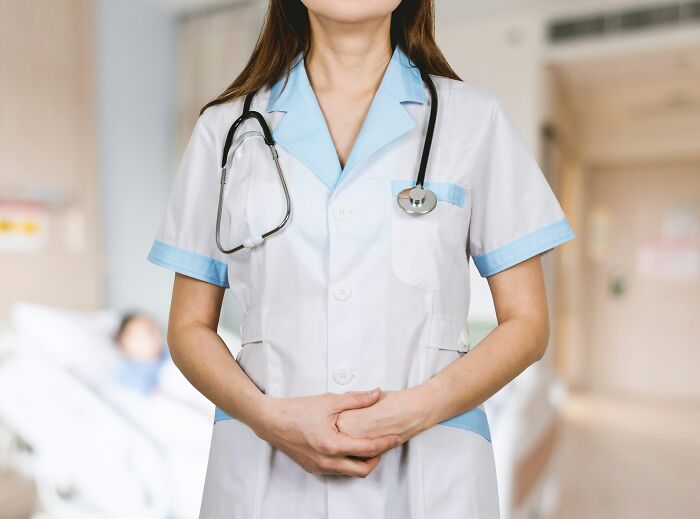 A healthcare professional wearing a stethoscope at work, showing commitment in a demanding economy.