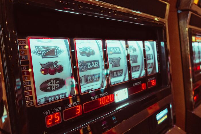 A close-up of a slot machine with flashing lights, showing common stereotypes about the US.
