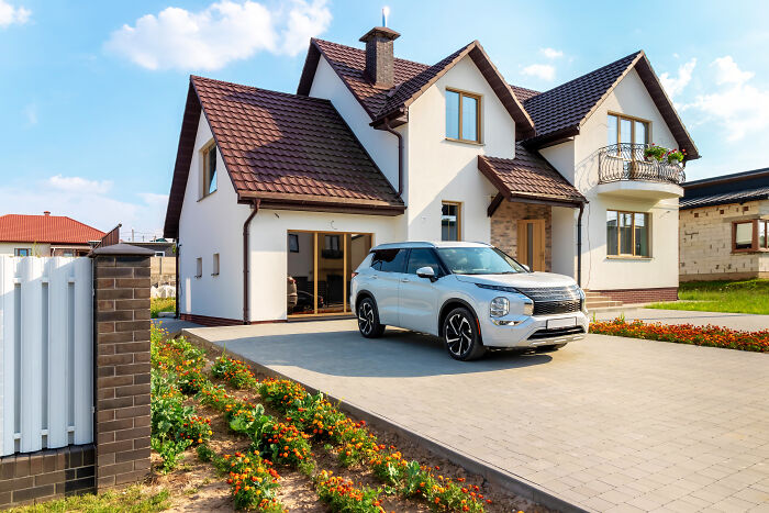 A white SUV parked in front of a modern house, a lifestyle element tied to marriage regrets
