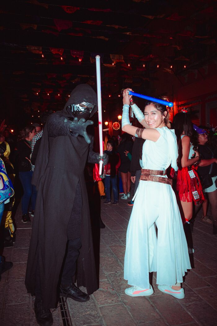 Two people dressed as Star Wars characters Kylo Ren and Rey, a wild turn at a themed wedding.