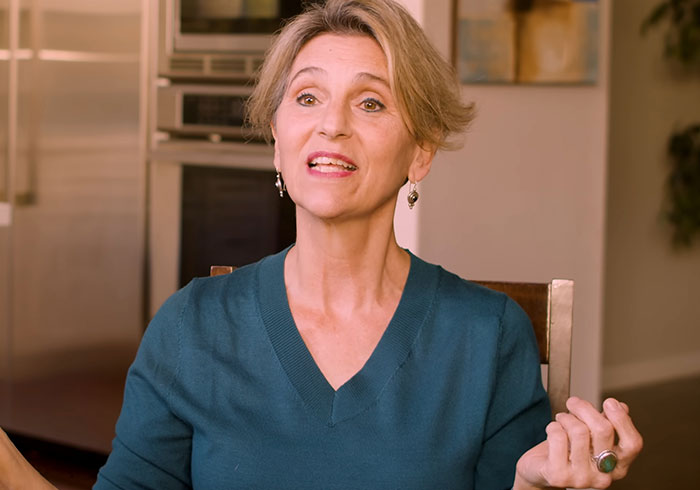 A woman with short blonde hair and earrings gesturing as she recounts her materialist atheist perspective before she flatlined. A woman with short blonde hair and earrings gesturing as she recounts her materialist atheist perspective before she flatlined.