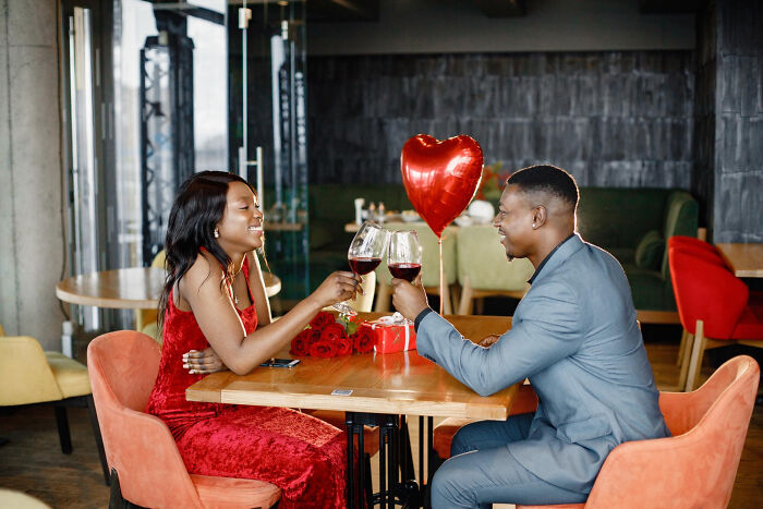 A happy couple having a romantic first date together at a restaurant table. A happy couple having a romantic first date together at a restaurant table.