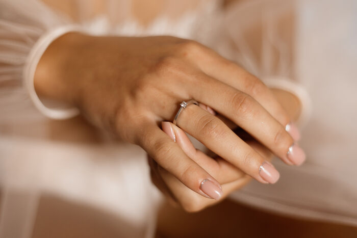 A woman wearing a simple ring, symbolizing the beginning of a life free of marriage regrets.