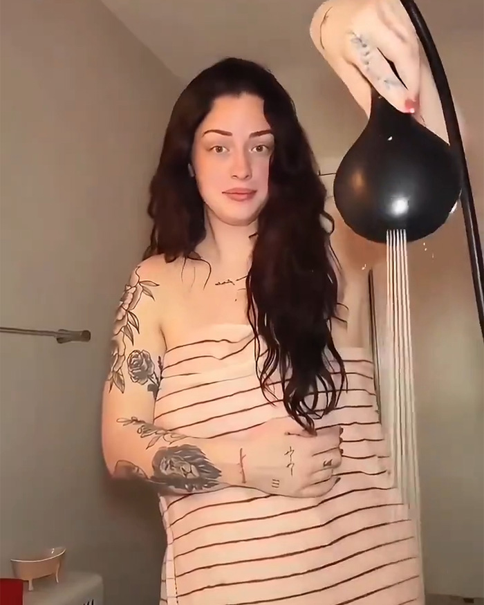 A woman holds an innovative handheld shower head, one of the amazing gadgets designed by women. A woman holds an innovative handheld shower head, one of the amazing gadgets designed by women.