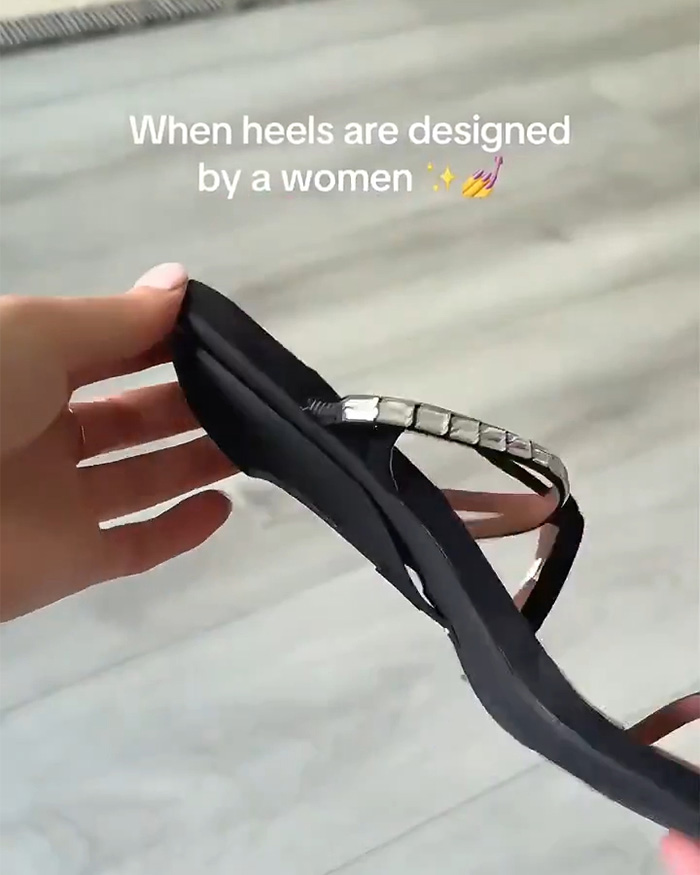 A black sandal with a detachable heel, an amazing gadget designed by women, held up. A black sandal with a detachable heel, an amazing gadget designed by women, held up.
