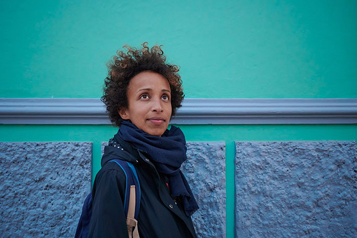 Woman looking up thoughtfully, having turned down marriage proposals and confident in her right choice.