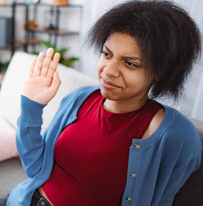 A woman turns down a marriage proposal with a clear gesture.