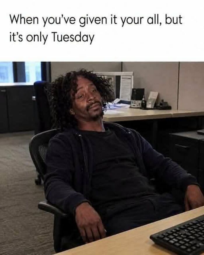 Tired man slouches in office chair only Tuesday work meme
