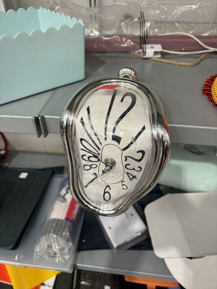 A melting clock in the style of Salvador Dali sitting on a shelf, a quirky thrift store find
