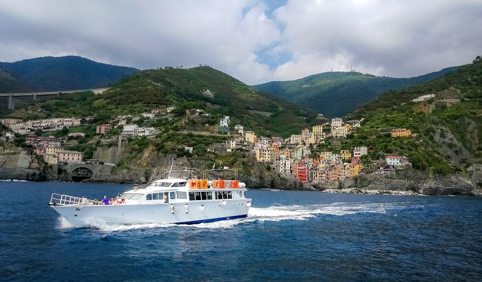 White boat cruising near colorful coastal town vacation destination