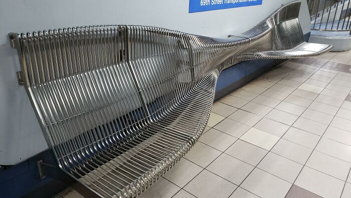 Uncomfortable wavy metal bench at a transit station illustrating Terrible Product Design
