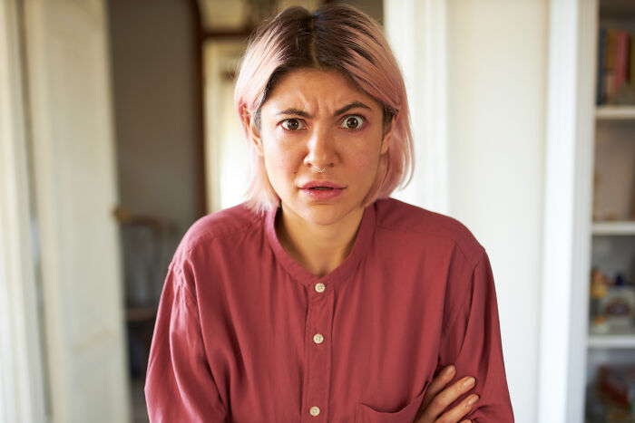 A woman with a shocked expression, possibly reacting to crazy and unhinged lies.