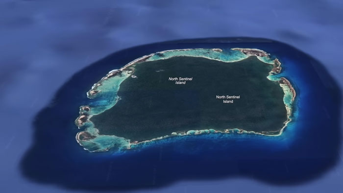 An aerial view of North Sentinel Island, one of the most dangerous islands in the world, surrounded by blue water.