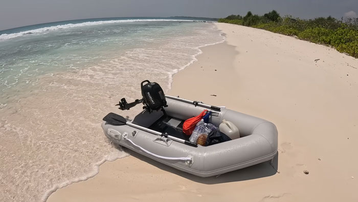 An inflatable boat on the sandy shore of one of the most dangerous islands in the world.