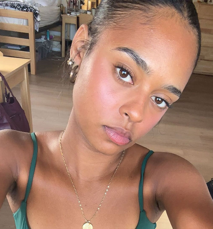 Close-up selfie of young woman in casual green top indoors Close-up selfie of young woman in casual green top indoors