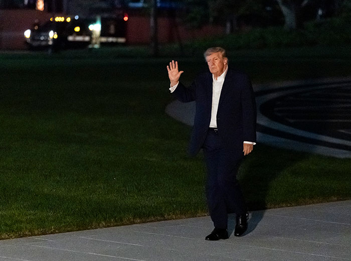 Donald Trump waving as he takes a walk on the White House lawn. Donald Trump waving as he takes a walk on the White House lawn.