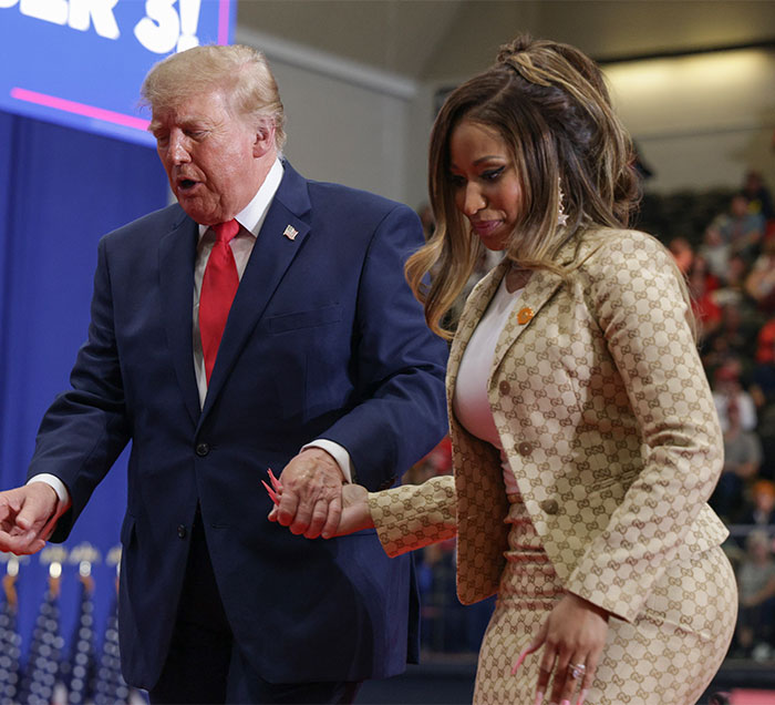 Nicki Minaj holding hands with Donald Trump at a rally event