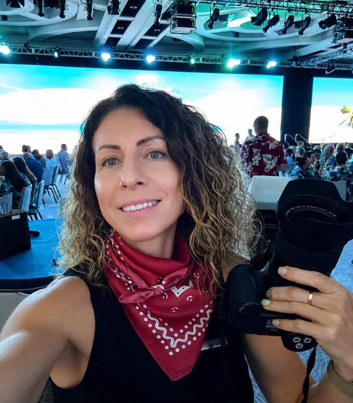 A photographer smiling during a work trip before a mom was arrested for leaving kids home alone. A photographer smiling during a work trip before a mom was arrested for leaving kids home alone.