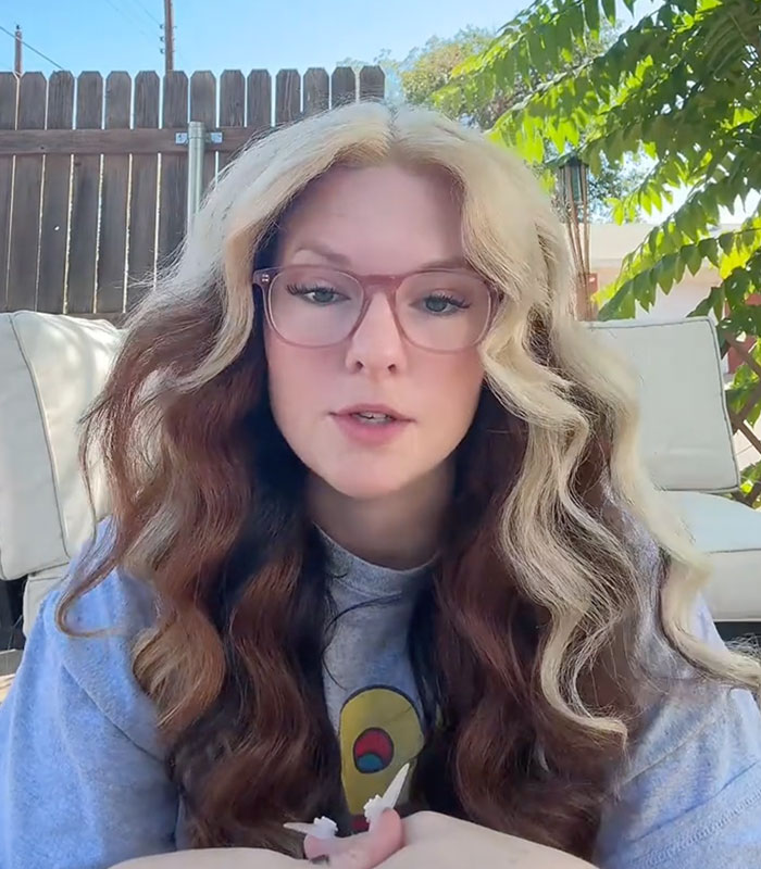 Close-up of a woman with glasses and wavy blonde and brown hair reflecting on her past relationship Close-up of a woman with glasses and wavy blonde and brown hair reflecting on her past relationship