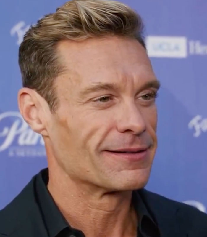 Close-up of Ryan Seacrest smiling, showcasing his recent body transformation. Close-up of Ryan Seacrest smiling, showcasing his recent body transformation.