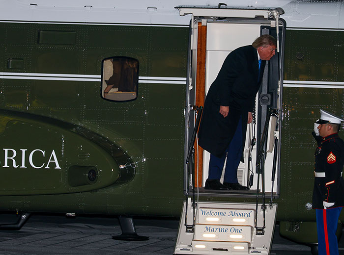 Donald Trump boarding Marine One helicopter at night. Donald Trump boarding Marine One helicopter at night.