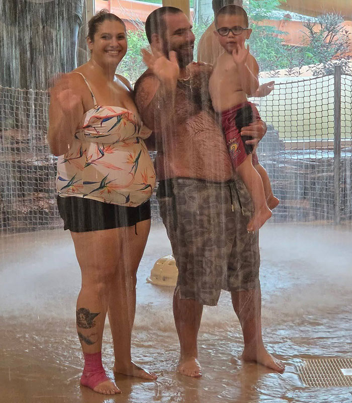 Family waving under water feature at popular family resort