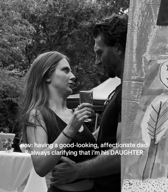 A black-and-white image capturing a close bond between a daughter and her dad at an event.