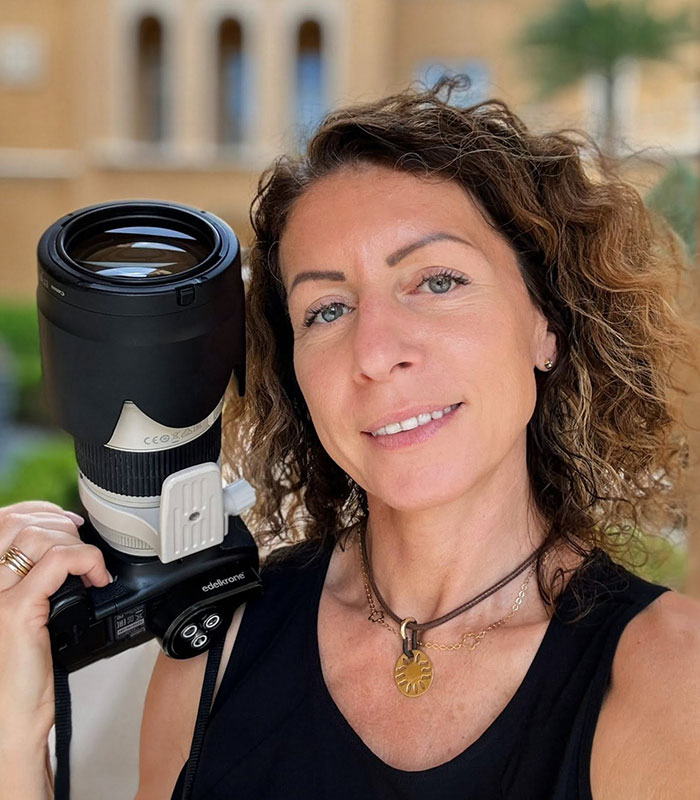 Close-up portrait of the mom arrested after leaving kids home alone, holding a professional camera Close-up portrait of the mom arrested after leaving kids home alone, holding a professional camera