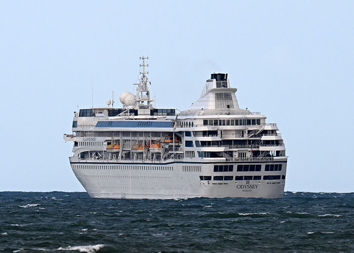 A large luxury ocean liner sailing at sea, representing a permanent cruise ship voyage.