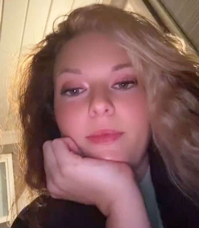 A thoughtful woman resting her chin on her hand, remembering a man she dated for four years A thoughtful woman resting her chin on her hand, remembering a man she dated for four years