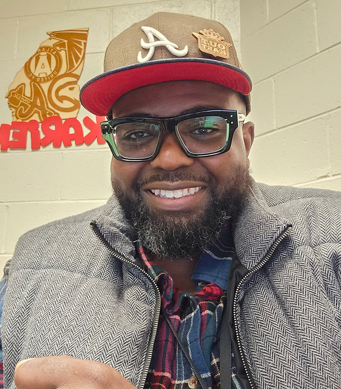 Man wearing a baseball cap smiling, identified as the father in a viral Six Flags accident.