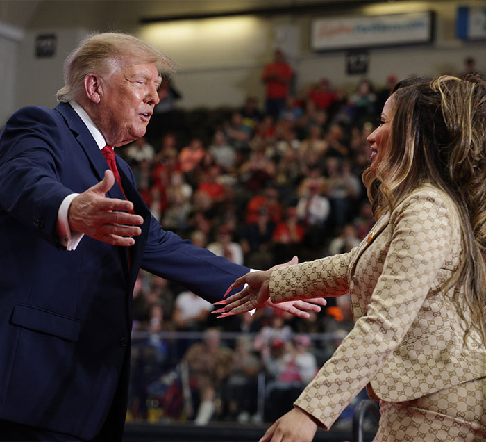 Nicki Minaj reaching out to shake hands with Donald Trump at a rally