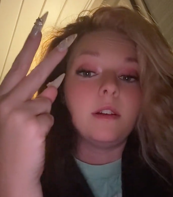 A shocked woman showing her nails as she describes a man hiding a secret A shocked woman showing her nails as she describes a man hiding a secret