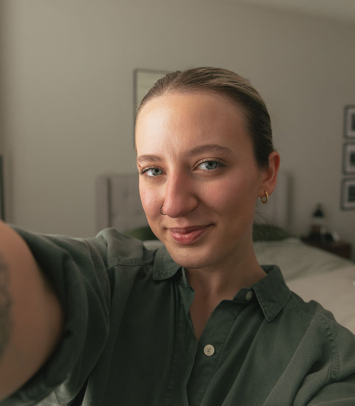 A smiling woman wearing a green shirt taking a selfie, representing marriage sacrifices