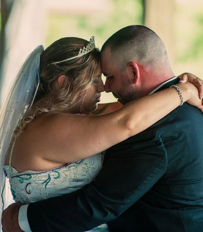 Bride and groom embracing closely on their wedding day