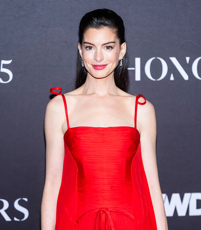 Actress with slicked back hair in red dress at formal event Actress with slicked back hair in red dress at formal event