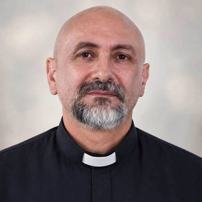 Portrait of priest wearing clerical collar and black shirt Portrait of priest wearing clerical collar and black shirt