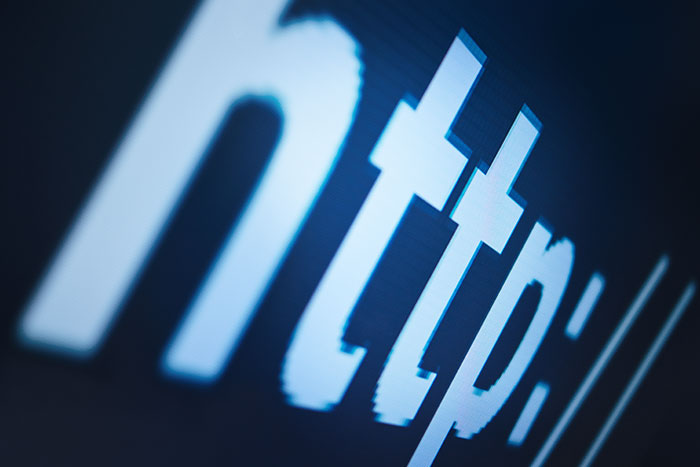Extreme close-up of http text on a monitor representing vulnerable internet infrastructure. Extreme close-up of http text on a monitor representing vulnerable internet infrastructure.