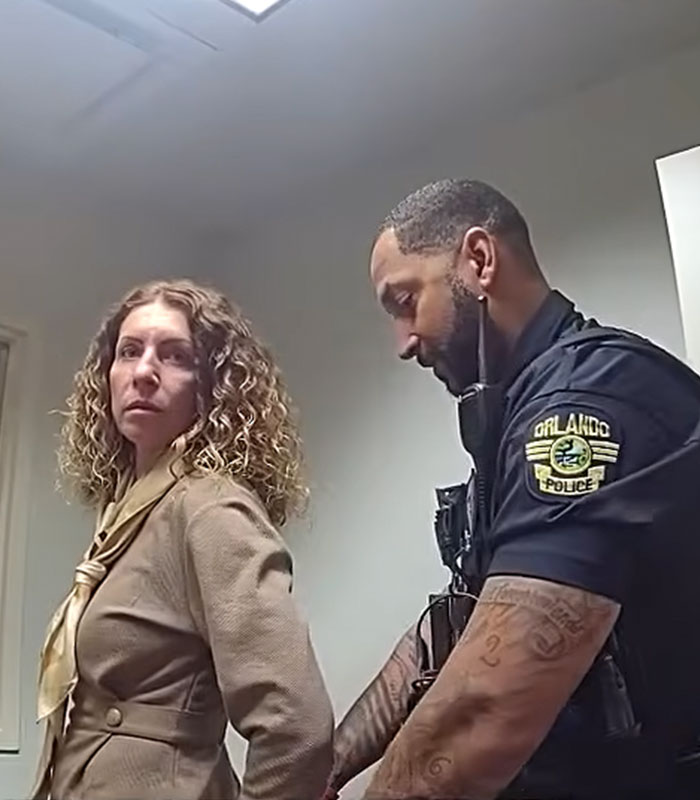 Orlando police officer detaining a mom arrested after leaving kids home alone for a trip Orlando police officer detaining a mom arrested after leaving kids home alone for a trip