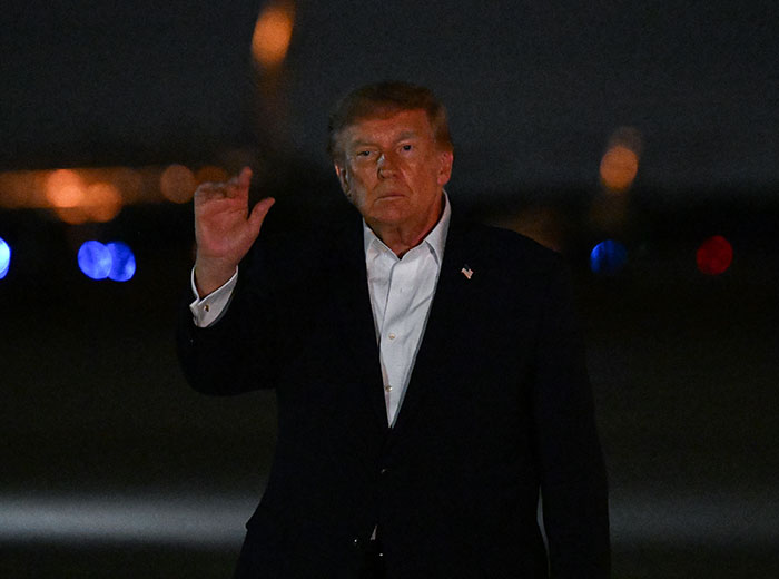 Donald Trump waving under a dark sky, highlighting discussions around Trump's Path To Air Force One. Donald Trump waving under a dark sky, highlighting discussions around Trump's Path To Air Force One.