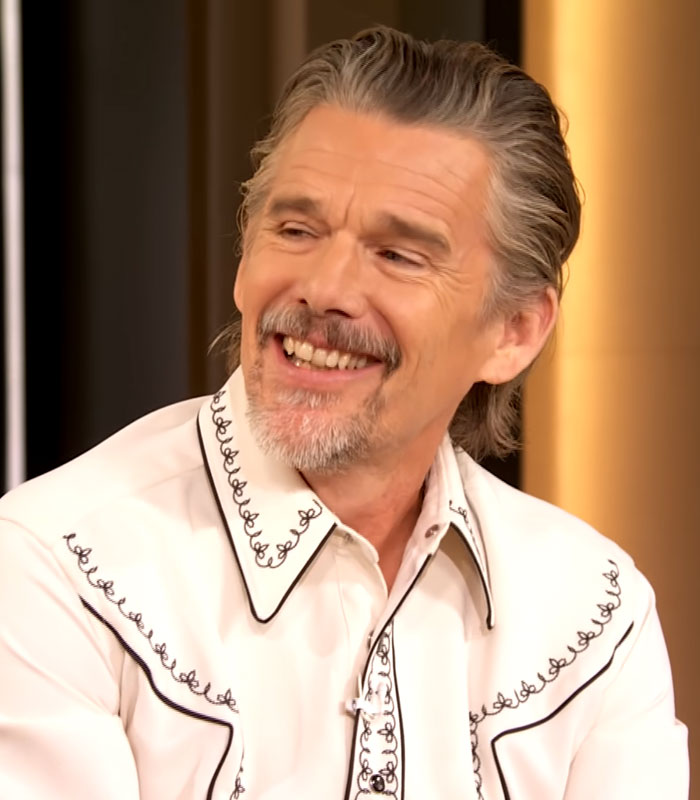 Ethan Hawke smiling during an interview addressing his past dating confession and cheating scandal. Ethan Hawke smiling during an interview addressing his past dating confession and cheating scandal.