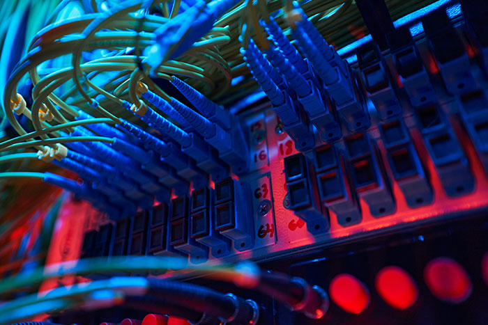 Server rack with blue network cables highlighting potential targets for AI agent swarms. Server rack with blue network cables highlighting potential targets for AI agent swarms.